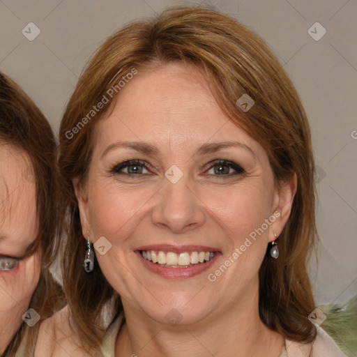 Joyful white adult female with medium  brown hair and blue eyes