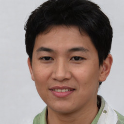 Joyful asian young-adult male with short  black hair and brown eyes