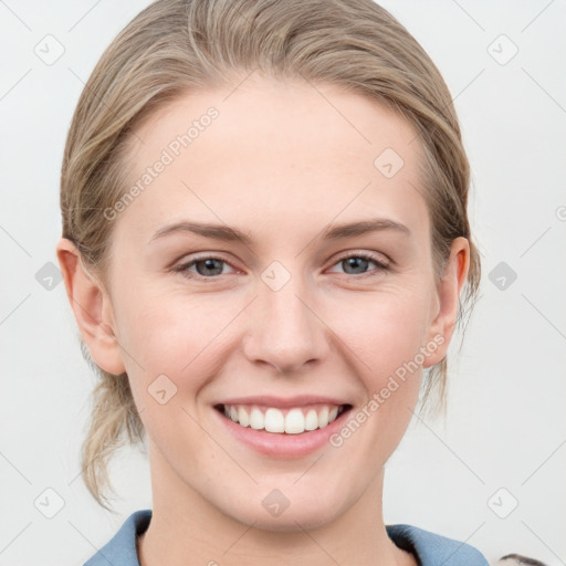 Joyful white young-adult female with medium  brown hair and blue eyes