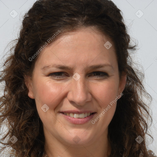 Joyful white adult female with long  brown hair and brown eyes