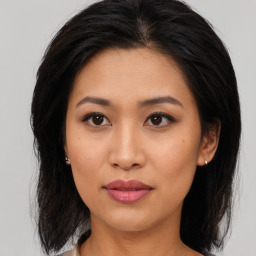 Joyful asian young-adult female with medium  brown hair and brown eyes