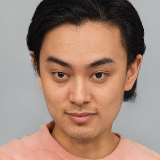 Joyful asian young-adult male with short  brown hair and brown eyes