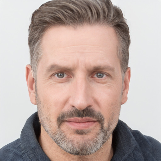 Joyful white adult male with short  brown hair and grey eyes