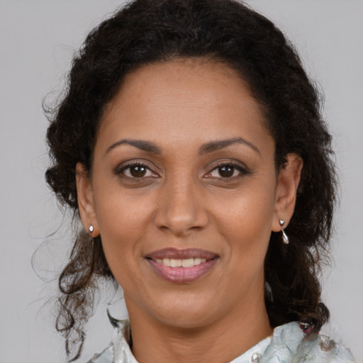 Joyful black adult female with medium  brown hair and brown eyes