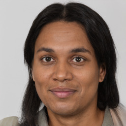 Joyful black adult female with medium  brown hair and brown eyes