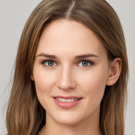 Joyful white young-adult female with long  brown hair and grey eyes