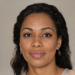 Joyful black adult female with medium  brown hair and brown eyes