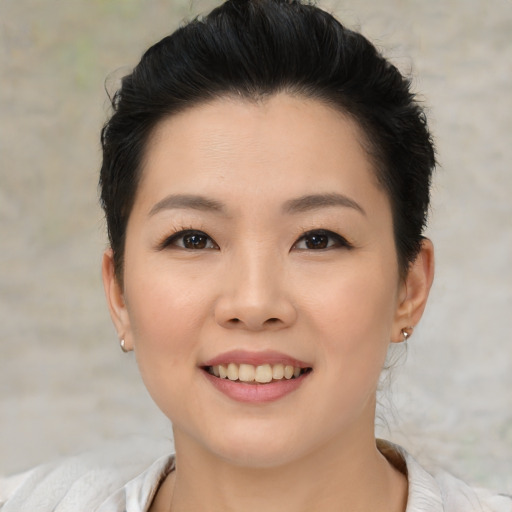 Joyful asian young-adult female with short  brown hair and brown eyes