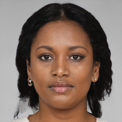 Joyful black young-adult female with medium  black hair and brown eyes