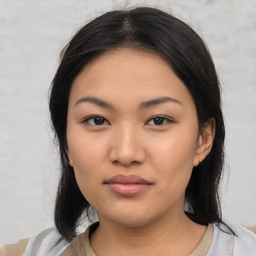 Joyful asian young-adult female with medium  black hair and brown eyes