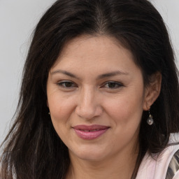 Joyful white adult female with long  brown hair and brown eyes