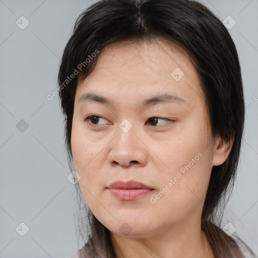 Joyful white adult female with medium  brown hair and brown eyes