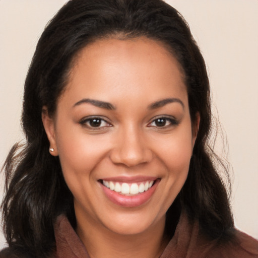 Joyful latino young-adult female with long  brown hair and brown eyes