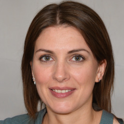 Joyful white adult female with medium  brown hair and blue eyes