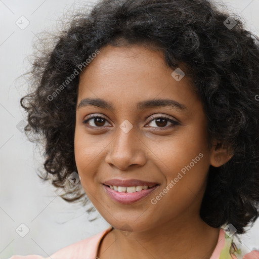 Joyful black young-adult female with long  brown hair and brown eyes