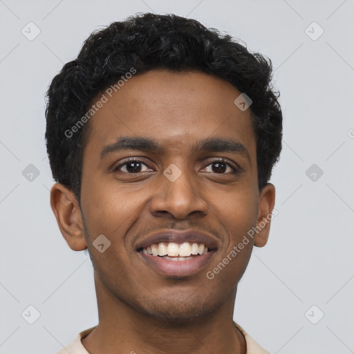 Joyful black young-adult male with short  black hair and brown eyes