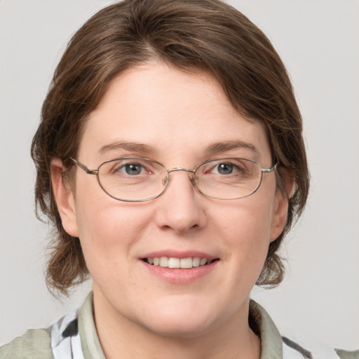 Joyful white adult female with medium  brown hair and blue eyes