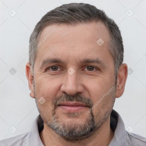 Joyful white adult male with short  brown hair and brown eyes