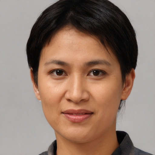 Joyful latino adult female with short  brown hair and brown eyes