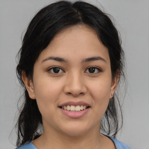 Joyful latino young-adult female with medium  black hair and brown eyes