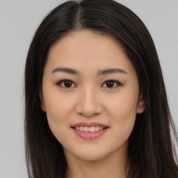 Joyful asian young-adult female with long  brown hair and brown eyes