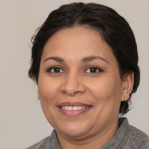 Joyful white adult female with short  brown hair and brown eyes
