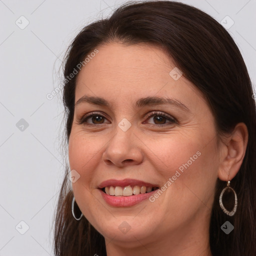 Joyful white young-adult female with long  brown hair and brown eyes