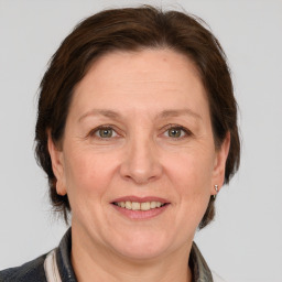 Joyful white adult female with medium  brown hair and grey eyes