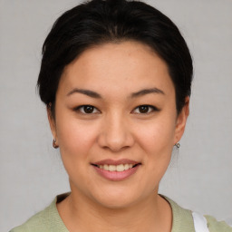 Joyful asian young-adult female with short  brown hair and brown eyes