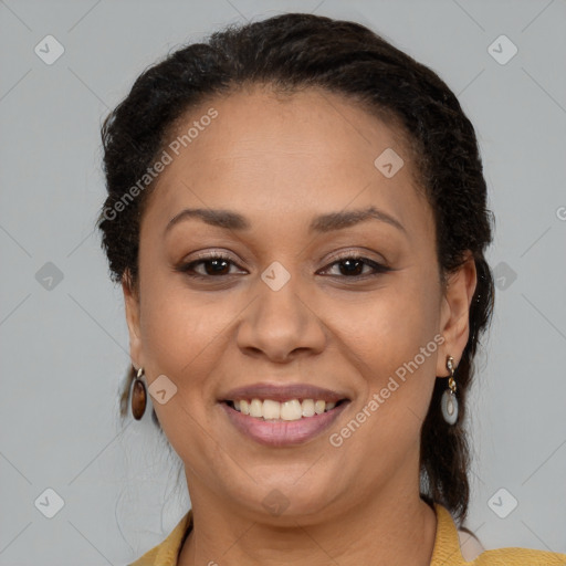 Joyful black adult female with medium  brown hair and brown eyes