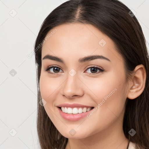 Joyful white young-adult female with long  brown hair and brown eyes