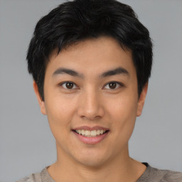 Joyful asian young-adult male with short  black hair and brown eyes