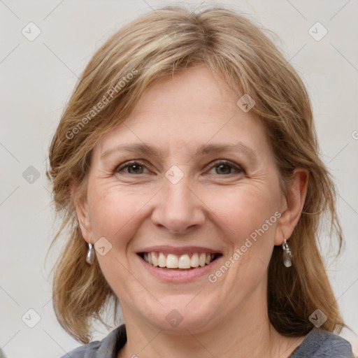 Joyful white adult female with medium  brown hair and grey eyes