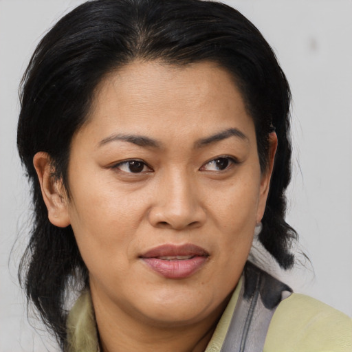 Joyful asian adult female with medium  brown hair and brown eyes