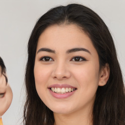 Joyful latino young-adult female with long  brown hair and brown eyes