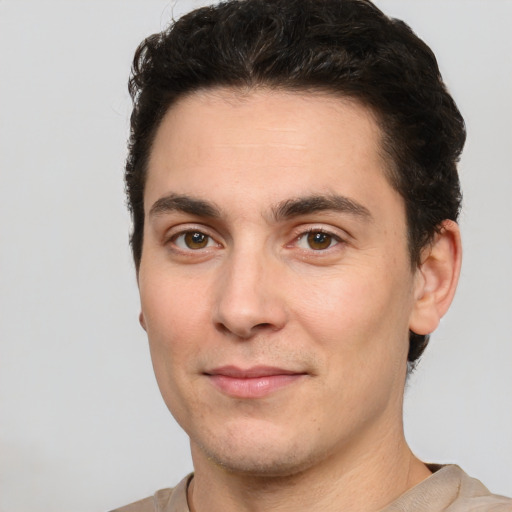 Joyful white young-adult male with short  black hair and brown eyes