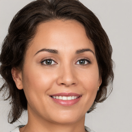 Joyful white young-adult female with medium  brown hair and brown eyes