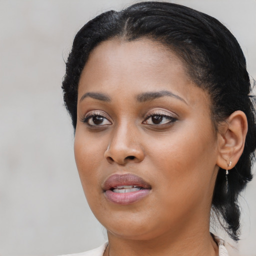 Joyful black young-adult female with medium  black hair and brown eyes
