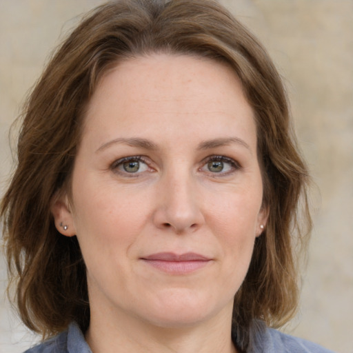 Joyful white adult female with medium  brown hair and grey eyes