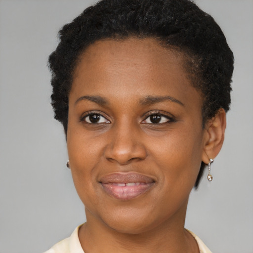 Joyful black young-adult female with short  brown hair and brown eyes