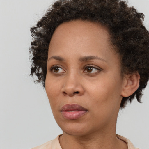 Neutral black young-adult female with short  brown hair and brown eyes