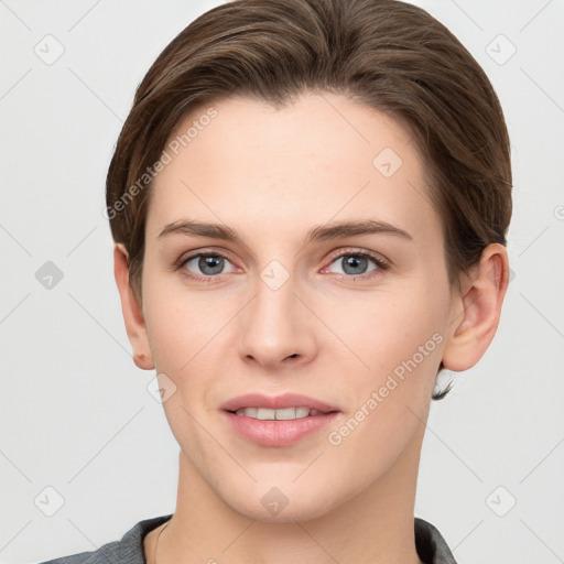 Joyful white young-adult female with short  brown hair and grey eyes