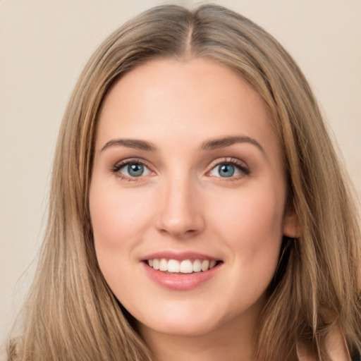 Joyful white young-adult female with long  brown hair and green eyes