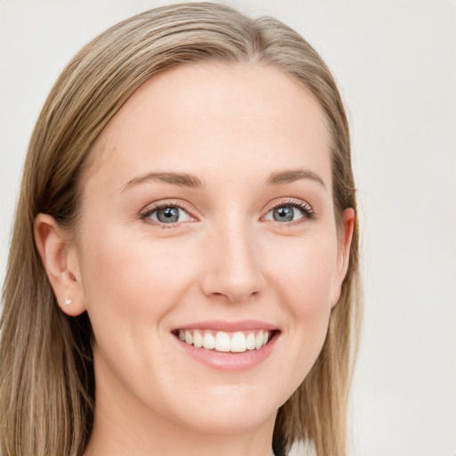 Joyful white young-adult female with long  brown hair and blue eyes