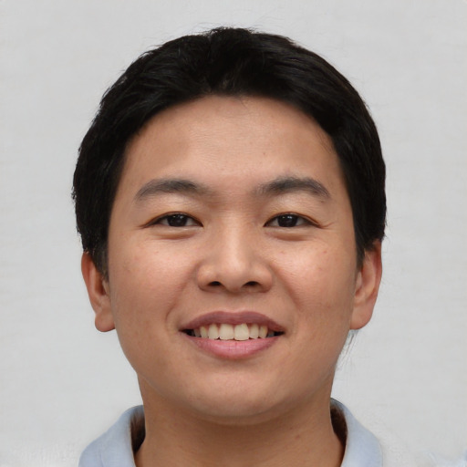 Joyful asian young-adult male with short  black hair and brown eyes