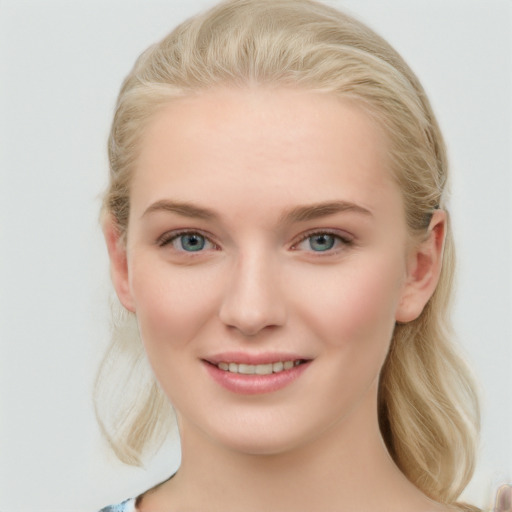 Joyful white young-adult female with long  brown hair and blue eyes