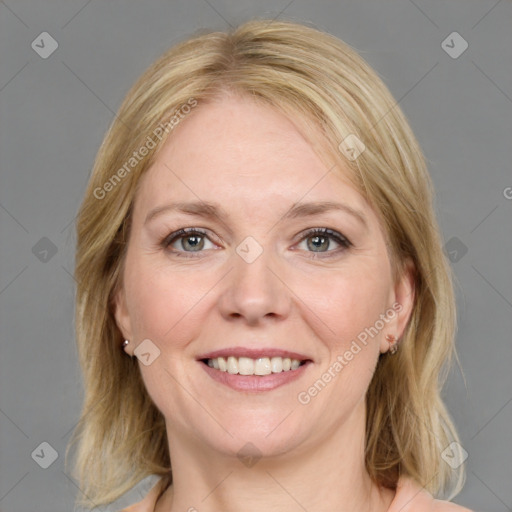 Joyful white young-adult female with medium  brown hair and blue eyes