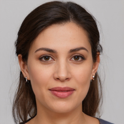 Joyful white young-adult female with medium  brown hair and brown eyes