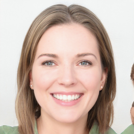 Joyful white young-adult female with medium  brown hair and green eyes