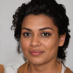 Joyful black young-adult female with medium  brown hair and brown eyes